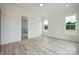 Bedroom with neutral paint, hardwood floors, and natural light from two large windows at 3622 E Brief Rd, Monroe, NC 28110