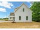 Exterior view of white siding, windows, roof and a manicured lawn ready for new home owners at 3622 E Brief Rd, Monroe, NC 28110
