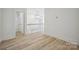 Open hallway featuring wood floors and view of railing, stairs, and a bathroom at 3622 E Brief Rd, Monroe, NC 28110