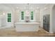 Stunning kitchen features an expansive island, stainless steel appliances, and abundant natural light at 3622 E Brief Rd, Monroe, NC 28110