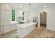 Bright, open kitchen features custom cabinets, a large island, and stainless steel appliances at 3622 E Brief Rd, Monroe, NC 28110