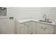Laundry space with utility sink and modern cabinetry featuring gold hardware at 3622 E Brief Rd, Monroe, NC 28110