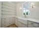 Well-designed laundry room with white cabinetry, ample storage, sink and stylish fixtures at 3622 E Brief Rd, Monroe, NC 28110