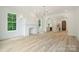 Open-concept living space features fireplace, windows and seamlessly connects to a modern kitchen at 3622 E Brief Rd, Monroe, NC 28110