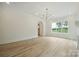 Spacious living room with hardwood floors, chandelier lighting, and large windows for natural light at 3622 E Brief Rd, Monroe, NC 28110