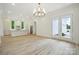 Spacious living area featuring a modern kitchen and access to the outdoors through glass doors at 3622 E Brief Rd, Monroe, NC 28110