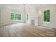 Cozy living room area featuring a fireplace, hardwood floors, and lots of natural lighting at 3622 E Brief Rd, Monroe, NC 28110