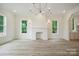 Open-concept living space, bright lighting, fireplace, and large windows overlooking the yard at 3622 E Brief Rd, Monroe, NC 28110