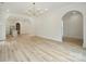 Open floor plan featuring archways, dining area, and light wood flooring at 3622 E Brief Rd, Monroe, NC 28110