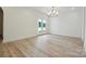 Bright and airy living area with hardwood floors and access to outdoor patio through glass doors at 3622 E Brief Rd, Monroe, NC 28110