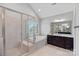 Bright bathroom featuring a glass shower, soaking tub, dark wood vanity, and granite countertops at 409 Wheatberry Hill Dr, Matthews, NC 28104