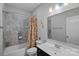 Cozy bathroom features a bathtub and shower combo with a vanity and decorative mirror at 409 Wheatberry Hill Dr, Matthews, NC 28104