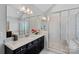 Bright bathroom features a glass-enclosed shower, granite countertop, and large vanity mirror at 409 Wheatberry Hill Dr, Matthews, NC 28104