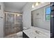 Bathroom features a tiled glass shower, dark wood vanity, and large mirror for a spa-like feel at 409 Wheatberry Hill Dr, Matthews, NC 28104
