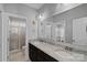 Bathroom featuring double sinks, granite countertops, and a large vanity mirror at 409 Wheatberry Hill Dr, Matthews, NC 28104