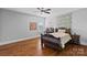 Comfortable bedroom with hardwood floors and a decorative wall and ceiling fan at 409 Wheatberry Hill Dr, Matthews, NC 28104