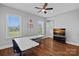 Spacious bonus room with a ceiling fan, wood floors, multiple windows, and a television at 409 Wheatberry Hill Dr, Matthews, NC 28104