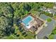 Aerial view of a sparkling community pool with lounge chairs, umbrellas, and a clubhouse for residents' enjoyment at 409 Wheatberry Hill Dr, Matthews, NC 28104