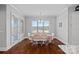 Comfortable dining room features a neutral color palette, wood floors, and a large window for natural light at 409 Wheatberry Hill Dr, Matthews, NC 28104