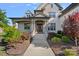Inviting front entrance with a covered porch, brick facade, and colorful landscaping for a warm and welcoming appeal at 409 Wheatberry Hill Dr, Matthews, NC 28104