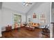 Bright living room with vaulted ceilings, hardwood floors, and large windows allowing ample natural light at 409 Wheatberry Hill Dr, Matthews, NC 28104