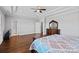 Spacious main bedroom showcasing wood floors, neutral walls, a tray ceiling, and tasteful furniture at 409 Wheatberry Hill Dr, Matthews, NC 28104