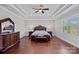 Expansive main bedroom features a tray ceiling, wood floors, and luxurious furnishings at 409 Wheatberry Hill Dr, Matthews, NC 28104