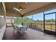 Relax on this screened patio with a dining area and views of the surrounding landscape at 409 Wheatberry Hill Dr, Matthews, NC 28104