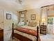 Cozy bedroom featuring a four-poster bed and a window with natural light at 4464 Mullens Ford Rd, Charlotte, NC 28226