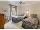 Comfortable bedroom with two twin beds, soft carpet, and a ceiling fan at 4464 Mullens Ford Rd, Charlotte, NC 28226