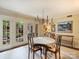 Bright dining room featuring elegant chandelier and doors leading to the outdoor space at 4464 Mullens Ford Rd, Charlotte, NC 28226