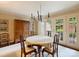 Classic dining room featuring a chandelier, a large armoire, and doors to an outdoor space at 4464 Mullens Ford Rd, Charlotte, NC 28226