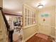 Welcoming foyer with hardwood floors, decorative partition and front door at 4464 Mullens Ford Rd, Charlotte, NC 28226