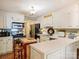 Bright kitchen features brick floors, white cabinets, stainless appliances, and ample counter space at 4464 Mullens Ford Rd, Charlotte, NC 28226