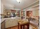 Charming kitchen with brick floors, a center island, and views to the living room at 4464 Mullens Ford Rd, Charlotte, NC 28226