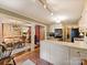 Open kitchen featuring brick floors, stainless steel appliances, and white cabinetry at 4464 Mullens Ford Rd, Charlotte, NC 28226