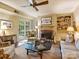 Inviting living room with fireplace, built-in shelves, and access to the backyard through French doors at 4464 Mullens Ford Rd, Charlotte, NC 28226