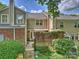 Back exterior featuring a brick patio and well-maintained landscaping at 4464 Mullens Ford Rd, Charlotte, NC 28226