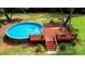 An aerial view shows an above ground swimming pool with a deck, complemented by green surroundings at 475 Dot Faris Rd, Catawba, SC 29704
