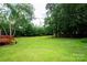 Expansive backyard showcases lush green lawn and mature trees, offering a serene outdoor setting at 475 Dot Faris Rd, Catawba, SC 29704