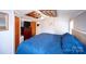 Cozy bedroom with unique mirrored ceiling feature and blue quilted bedding at 475 Dot Faris Rd, Catawba, SC 29704