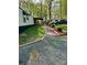 Single story home with a covered porch, brick walkway, and gravel driveway surrounded by trees at 475 Dot Faris Rd, Catawba, SC 29704