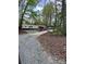 Single-story home with a gravel driveway surrounded by a tranquil wooded setting at 475 Dot Faris Rd, Catawba, SC 29704