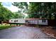 Charming single-story home featuring a covered porch, gravel driveway, and mature landscaping at 475 Dot Faris Rd, Catawba, SC 29704
