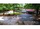 A single-story home featuring a manicured lawn, mature trees, and a gravel driveway at 475 Dot Faris Rd, Catawba, SC 29704