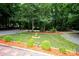 Landscaped front yard with mature trees, decorative mulch, and a central birdbath feature at 475 Dot Faris Rd, Catawba, SC 29704
