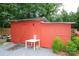 Red storage shed with multiple entry points surrounded by green shrubs at 475 Dot Faris Rd, Catawba, SC 29704