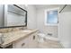 Bathroom with granite countertop vanity, white cabinets, tile floors and framed mirror at 506 7Th Sw St, Hickory, NC 28602