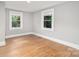 This bedroom is brightly lit with hardwood floors and white trim. Two windows bring the outside in at 506 7Th Sw St, Hickory, NC 28602
