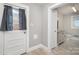 Hallway leading to bathroom, complete with tile floors, and exterior access with storm door at 506 7Th Sw St, Hickory, NC 28602